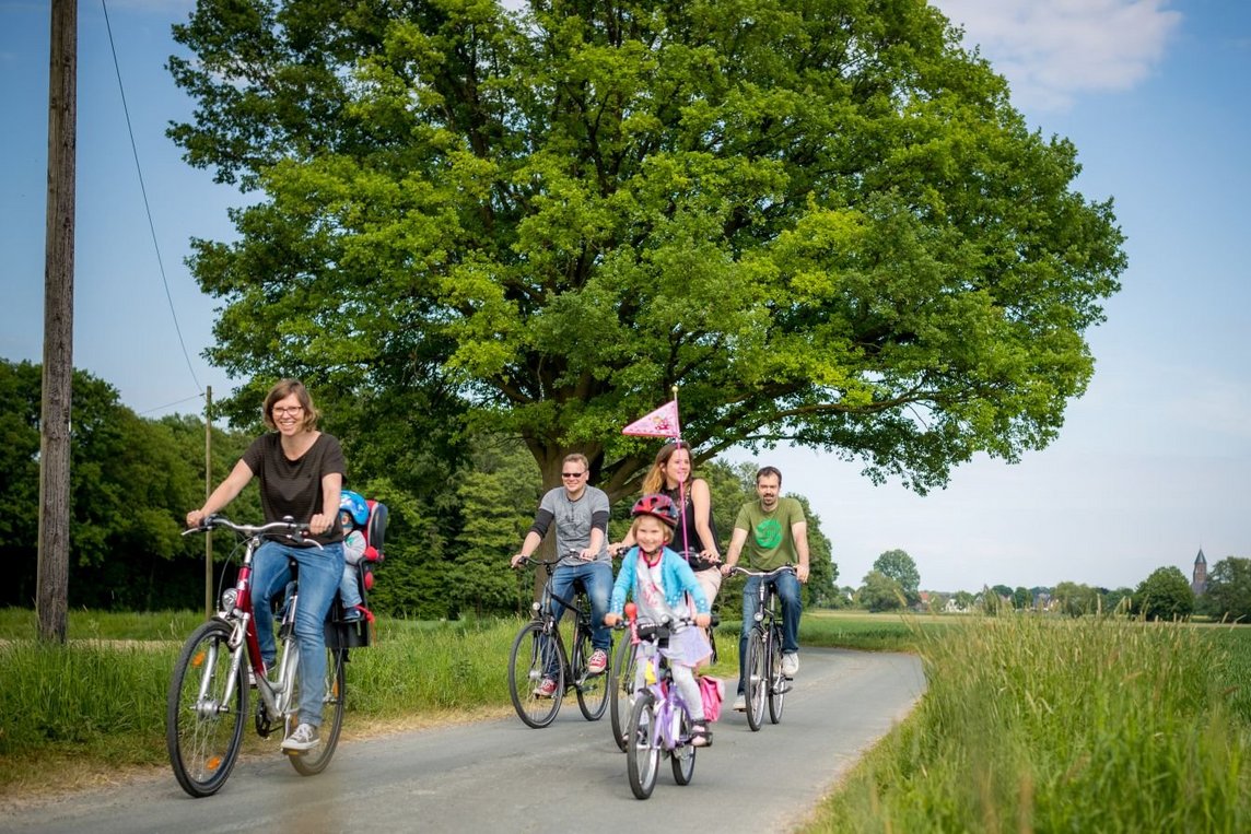 Das Bild zeigt eine Familie bei einer Radtour.